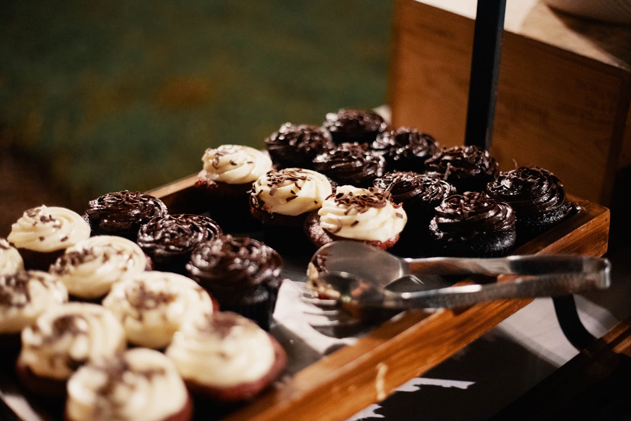 Close-up of chocolate and vanilla frosted cupcakes on a tray, perfect for desserts.