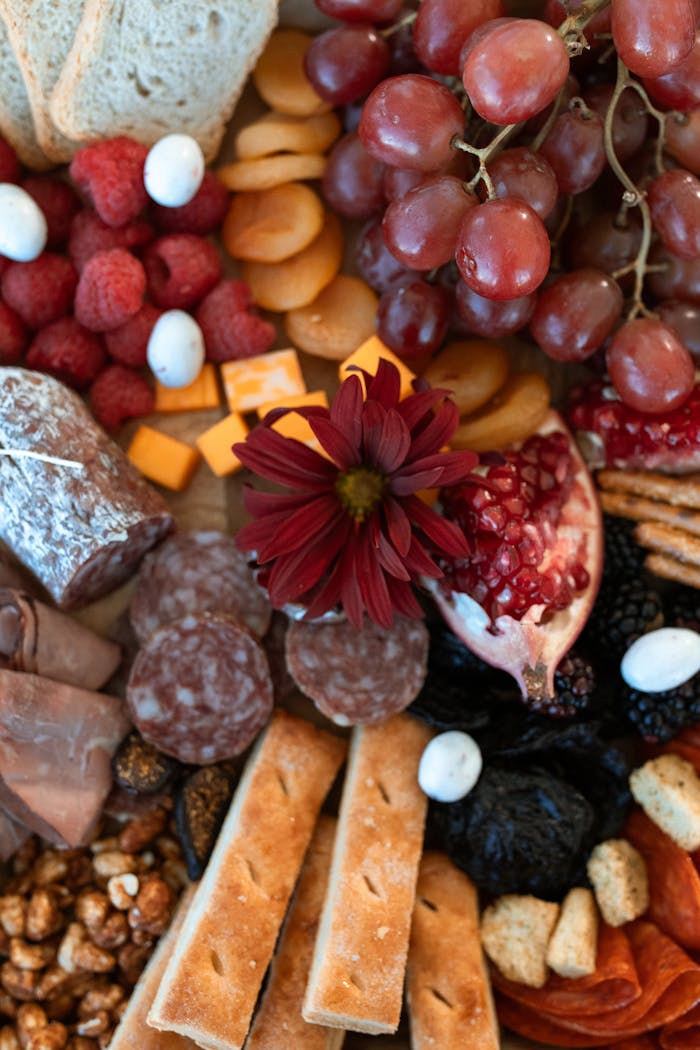 Artfully arranged charcuterie board featuring meats, cheeses, fruits, and nuts.