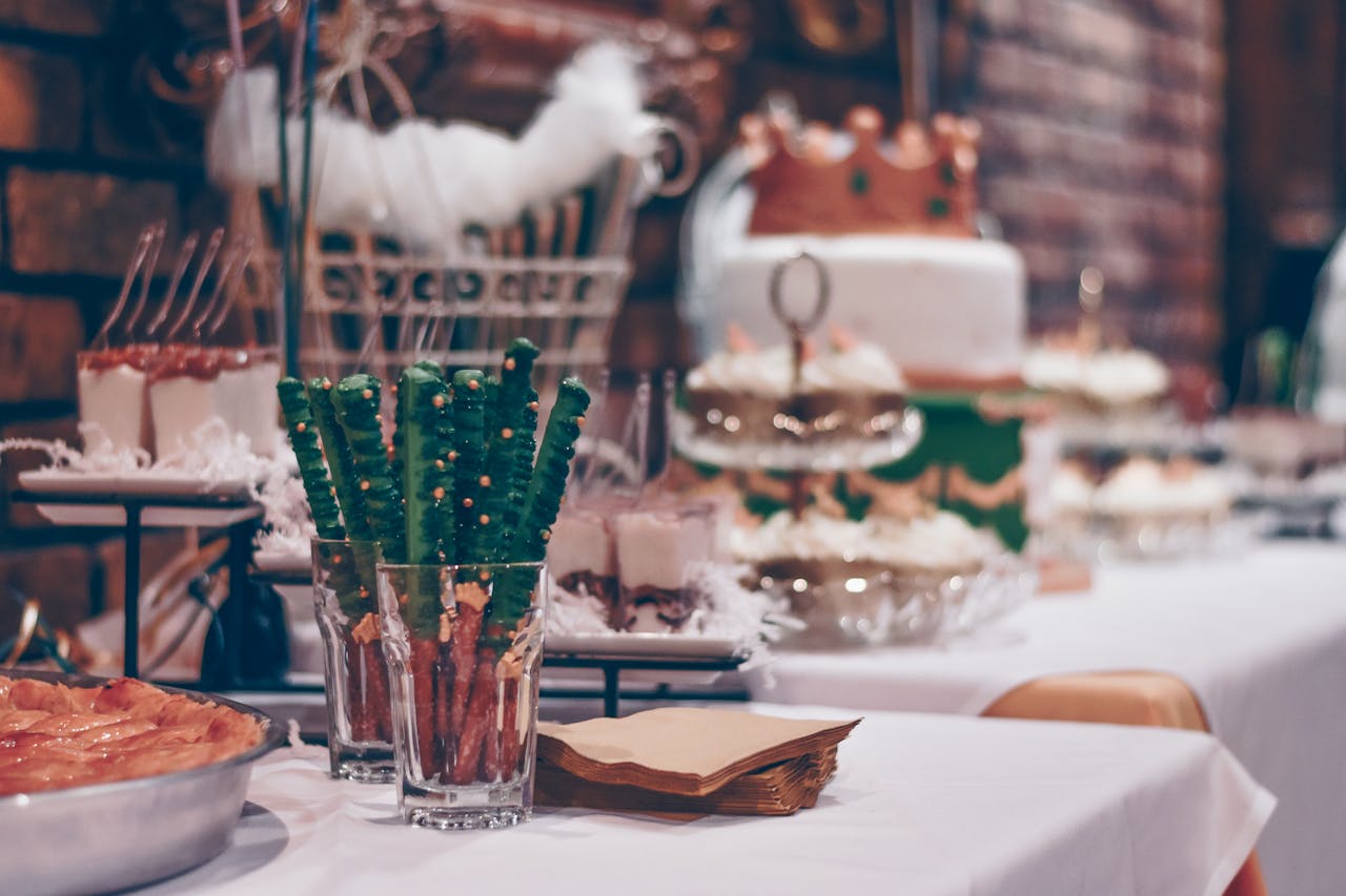 Close-up of a beautifully decorated dessert table at a festive event indoors.